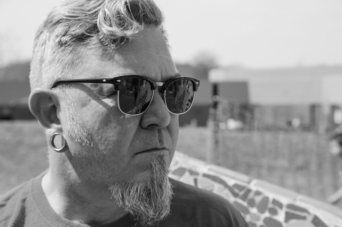 Close-up of Mighty Rock in sunglasses, looking off camera