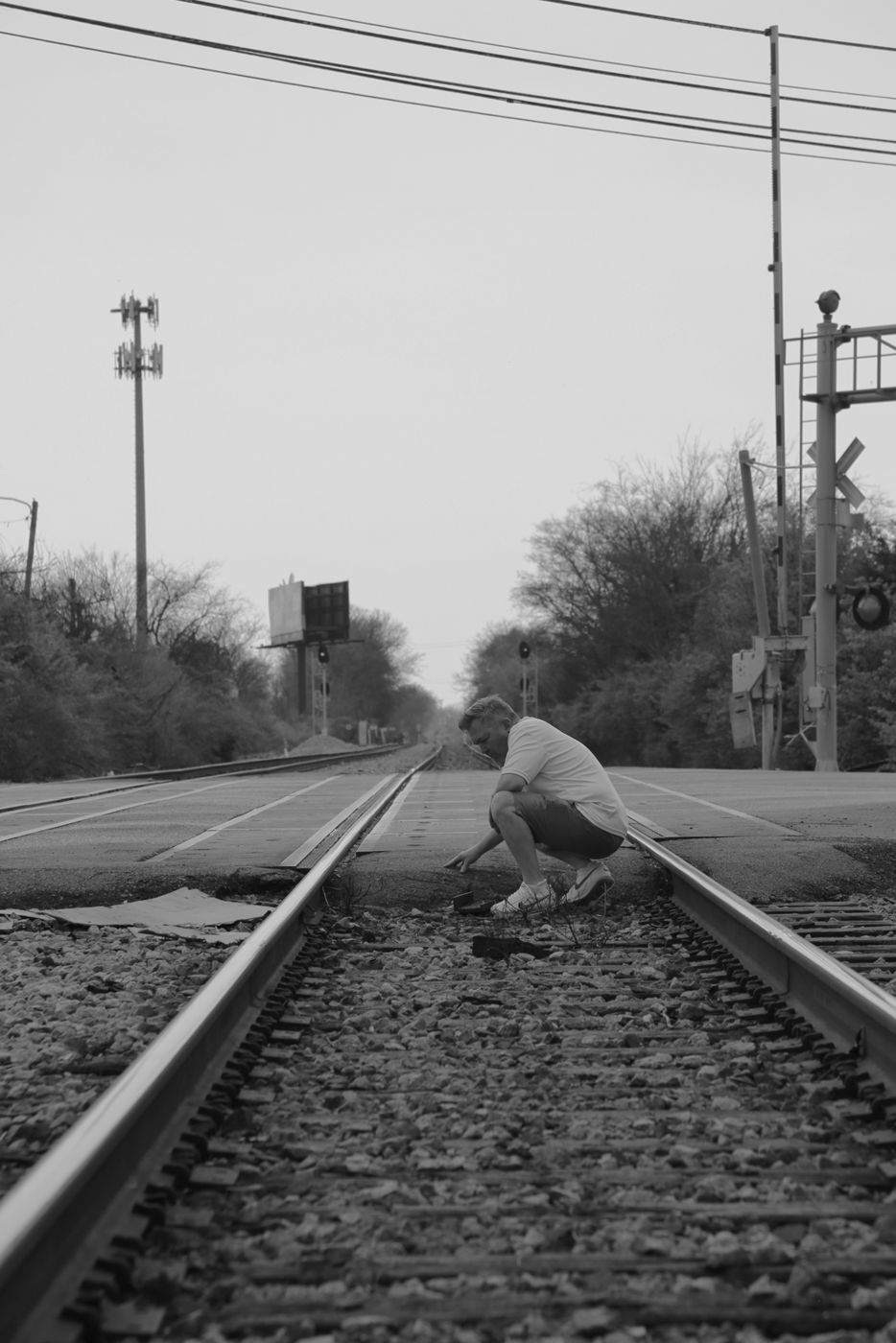 Mighty Rock crouching on railroad tracks